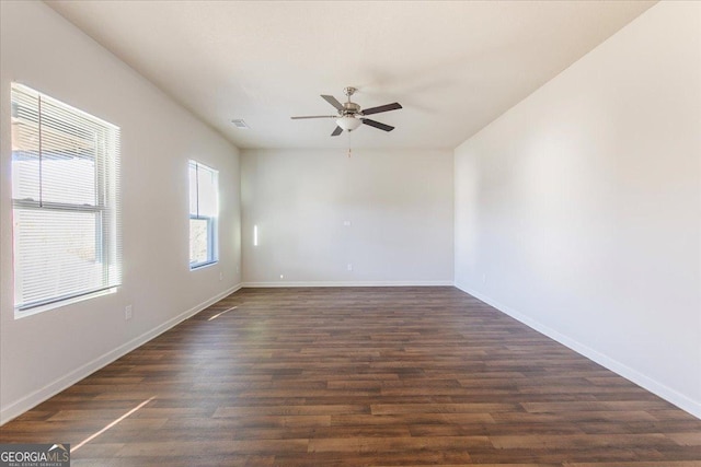 unfurnished room with ceiling fan and dark hardwood / wood-style flooring