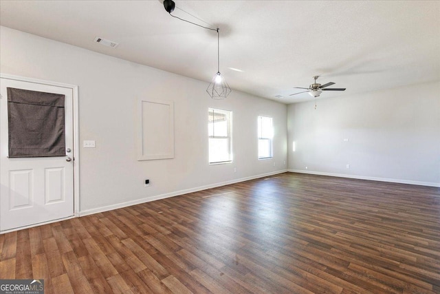 unfurnished room featuring ceiling fan and dark wood-type flooring