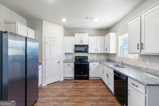 kitchen with black appliances, sink, white cabinets, and dark wood-type flooring