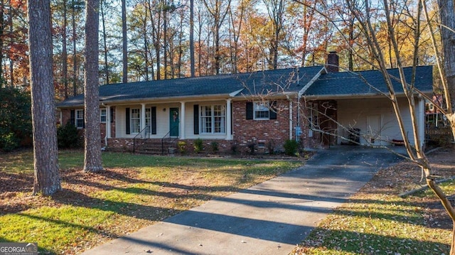 ranch-style house with a front yard, a porch, and a carport