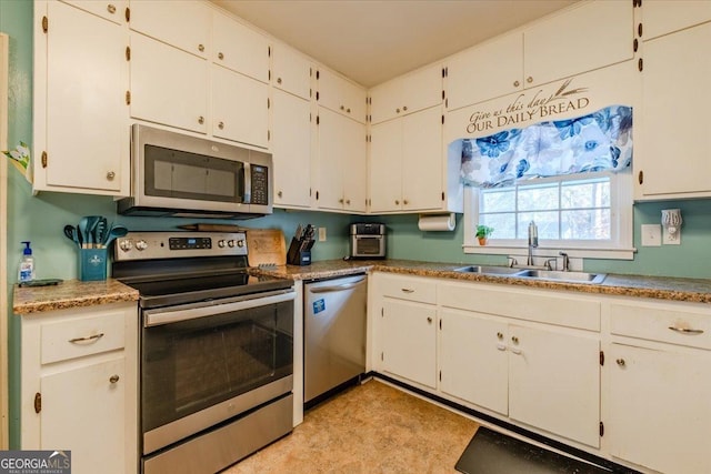 kitchen with white cabinets, sink, and appliances with stainless steel finishes