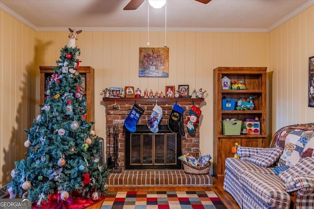 sitting room with hardwood / wood-style floors, a brick fireplace, ornamental molding, and wooden walls