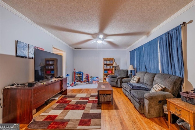 living room with hardwood / wood-style floors, a textured ceiling, ceiling fan, and crown molding