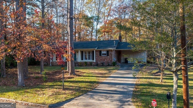 view of front of property with a carport and a front lawn