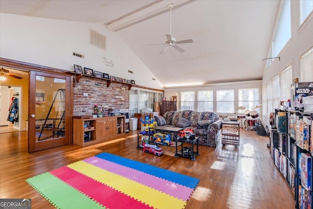 living room featuring beam ceiling, ceiling fan, hardwood / wood-style floors, and high vaulted ceiling