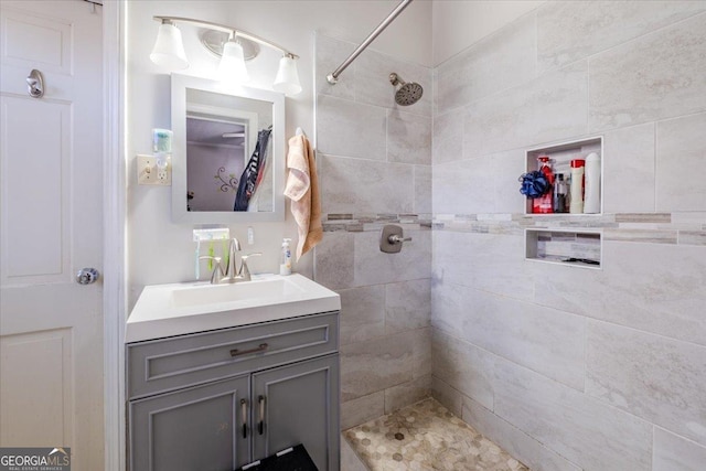 bathroom featuring vanity and a tile shower