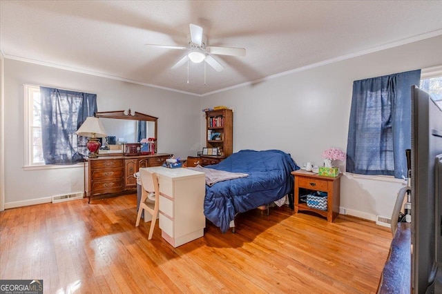 bedroom featuring ceiling fan, crown molding, light hardwood / wood-style flooring, and multiple windows