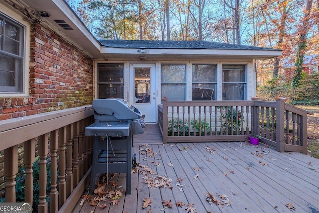 wooden terrace featuring area for grilling