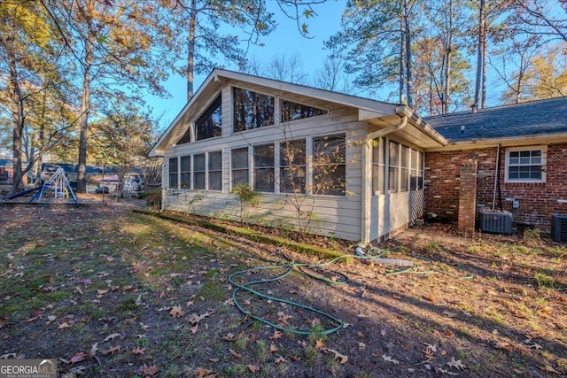 view of home's exterior with a sunroom