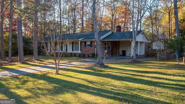 ranch-style home featuring a front yard and a carport