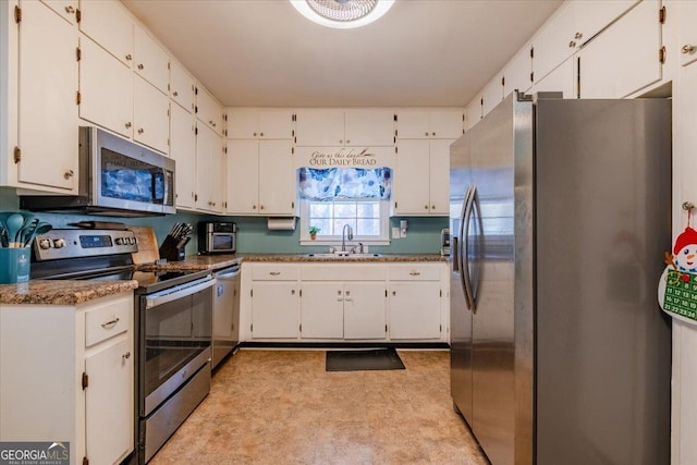 kitchen with white cabinets, stone countertops, sink, and stainless steel appliances