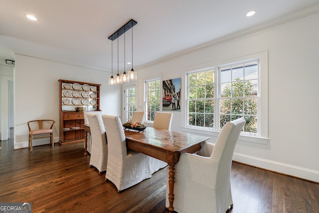 dining space featuring dark hardwood / wood-style floors and ornamental molding