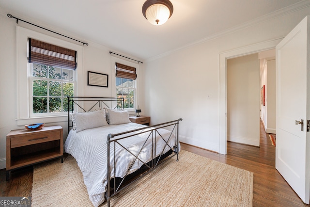 bedroom featuring hardwood / wood-style flooring and crown molding