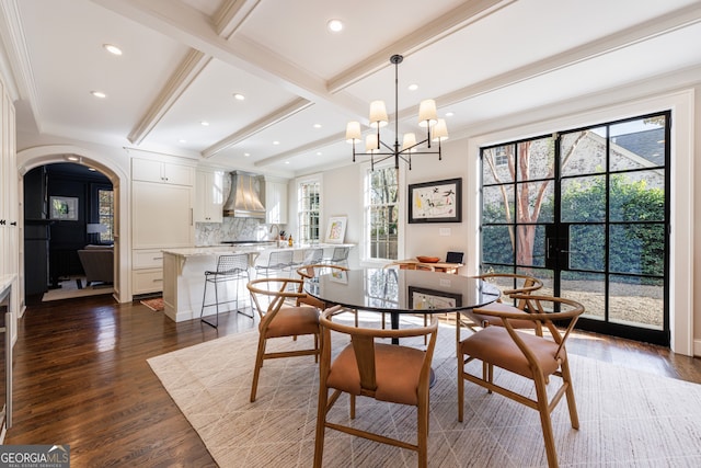 dining space featuring beam ceiling, dark hardwood / wood-style flooring, and plenty of natural light