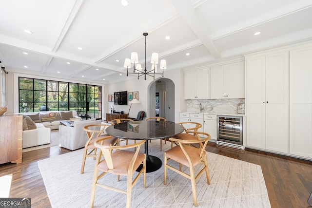 dining space with beam ceiling, beverage cooler, coffered ceiling, dark hardwood / wood-style floors, and a notable chandelier