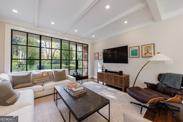 living room featuring beam ceiling, crown molding, and light wood-type flooring