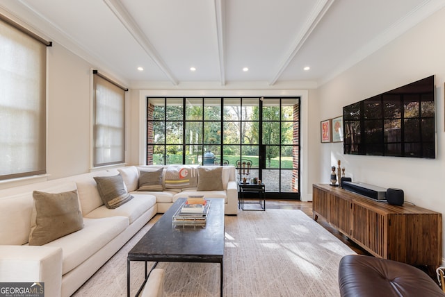 living room with beam ceiling, light hardwood / wood-style floors, and ornamental molding