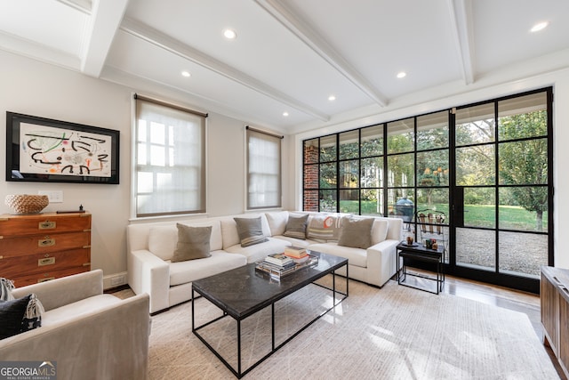 living room with beamed ceiling, light wood-type flooring, and a wealth of natural light