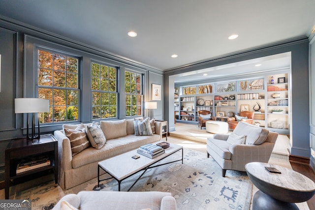 living room with hardwood / wood-style flooring and ornamental molding