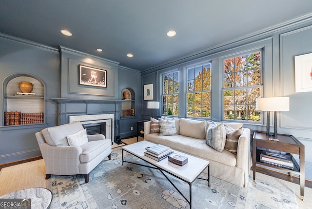 living room with crown molding and light hardwood / wood-style flooring