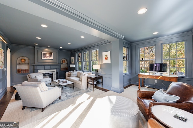 living room featuring ornamental molding and light hardwood / wood-style flooring