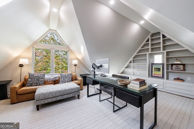 carpeted office with lofted ceiling