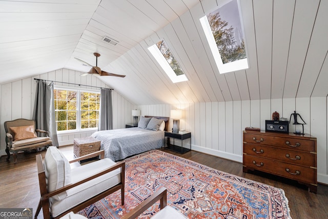 bedroom featuring ceiling fan, wood walls, lofted ceiling, and dark wood-type flooring