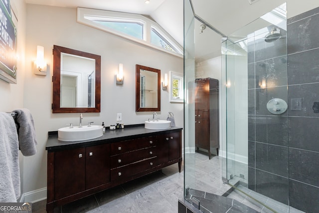 bathroom featuring vanity, an enclosed shower, and vaulted ceiling