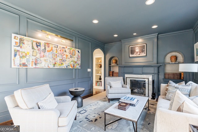 living room with hardwood / wood-style flooring and crown molding