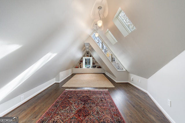 additional living space featuring dark hardwood / wood-style floors and lofted ceiling