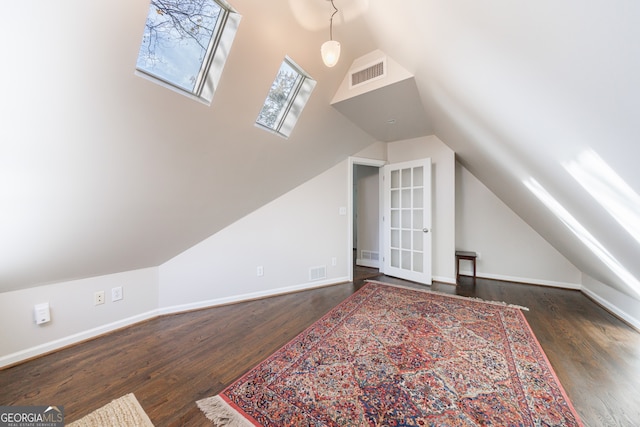 additional living space with dark hardwood / wood-style floors and vaulted ceiling