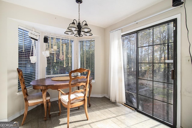 dining room featuring light hardwood / wood-style flooring and an inviting chandelier