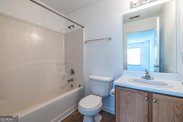 full bathroom featuring vanity, tile patterned flooring, toilet, a textured ceiling, and tub / shower combination