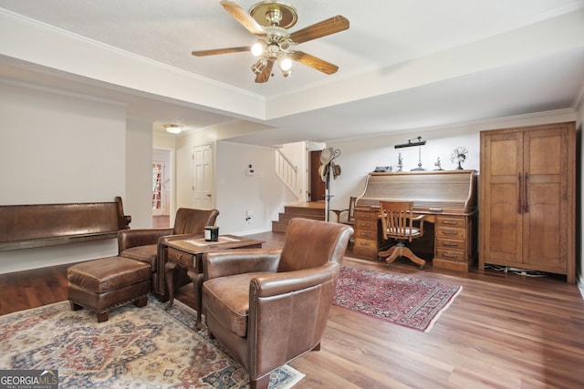 interior space with ceiling fan, crown molding, and light hardwood / wood-style flooring