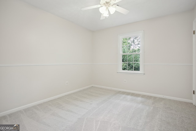 spare room with carpet flooring and ceiling fan