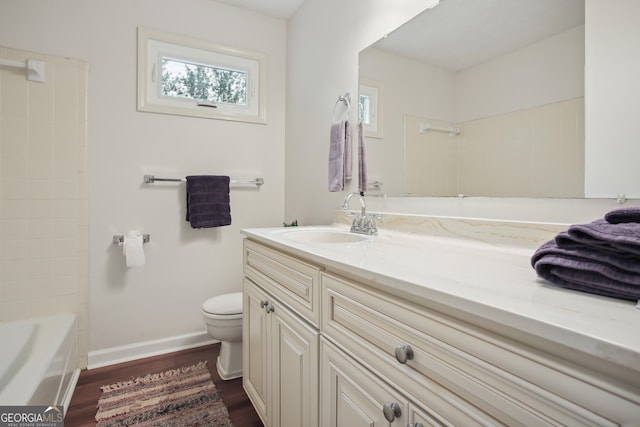 full bathroom with hardwood / wood-style floors, vanity, toilet, and shower / washtub combination