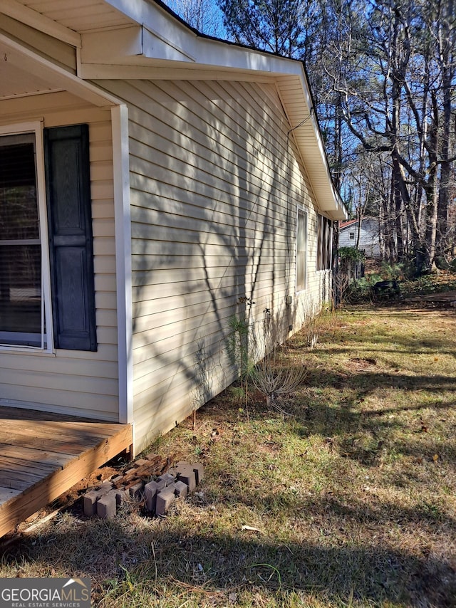 view of side of home featuring a wooden deck