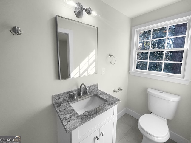 bathroom with tile patterned floors, vanity, and toilet