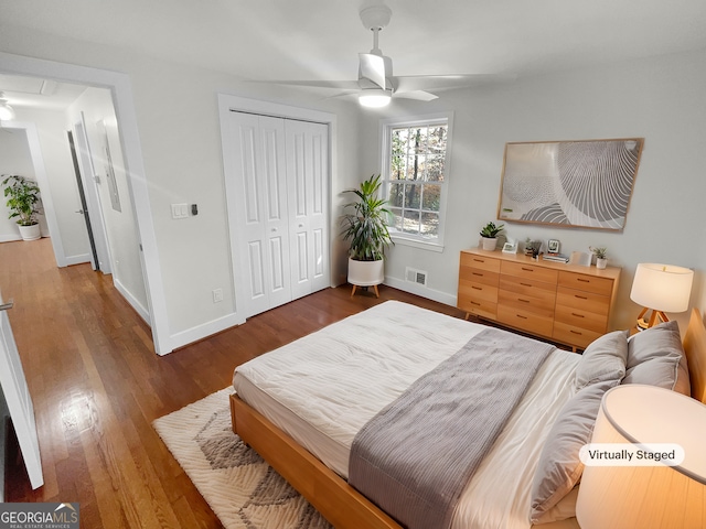 bedroom featuring a closet, ceiling fan, and dark wood-type flooring