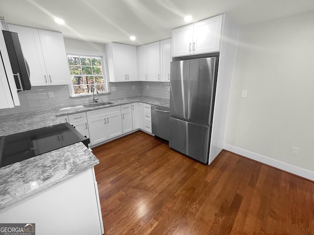 kitchen featuring dark hardwood / wood-style flooring, sink, white cabinetry, and stainless steel appliances