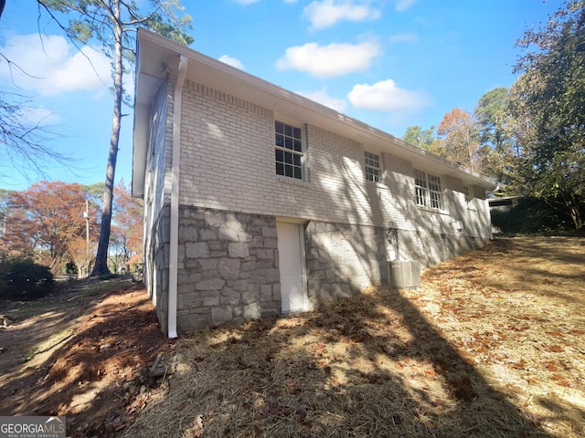 view of side of property with central air condition unit