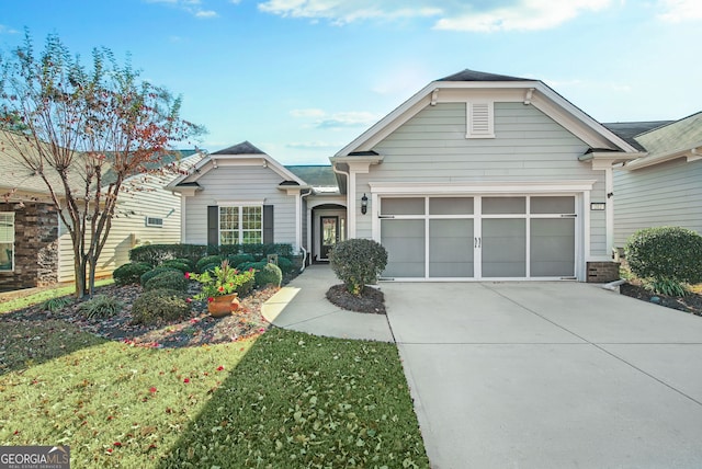 view of front of home with a garage and a front lawn