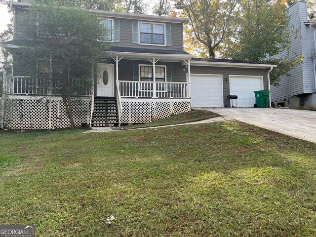 view of property featuring a front yard, a porch, and a garage