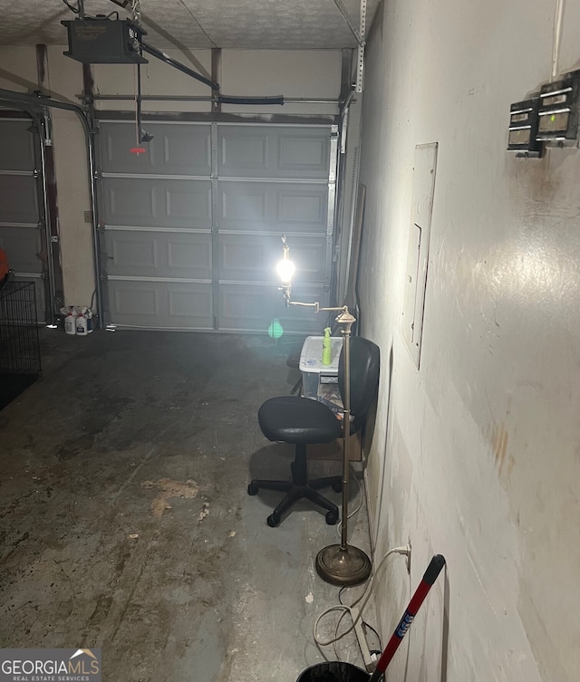 garage with a garage door opener and electric panel