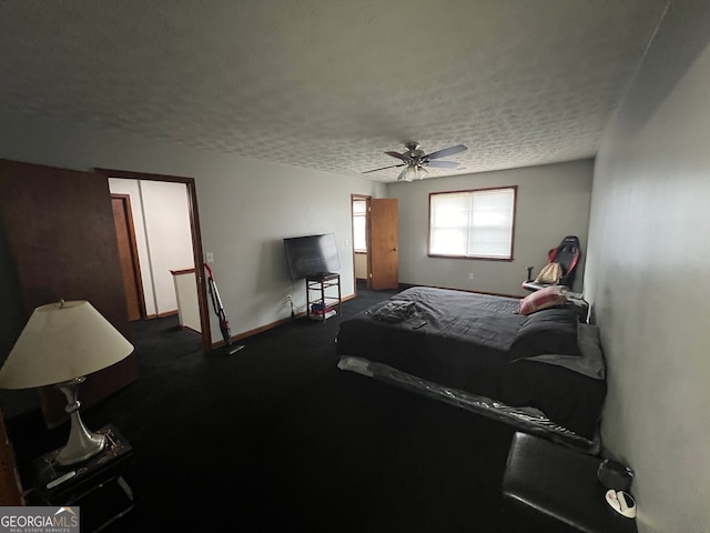 bedroom with a textured ceiling, ceiling fan, and baseboards