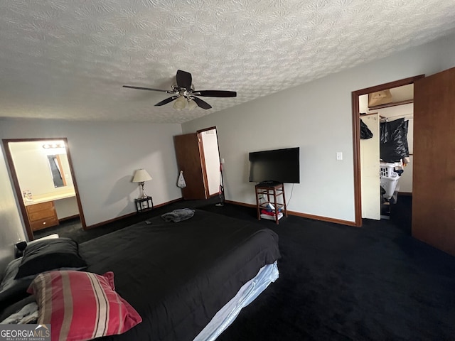 carpeted bedroom with a textured ceiling, a ceiling fan, and baseboards