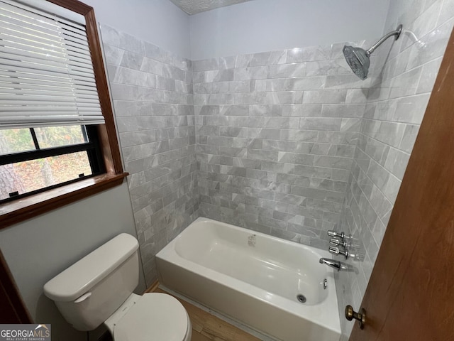 bathroom featuring bathtub / shower combination and toilet