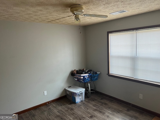 unfurnished room with visible vents, baseboards, and dark wood-style flooring