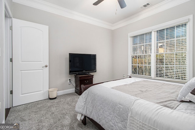 bedroom with crown molding, ceiling fan, and carpet floors