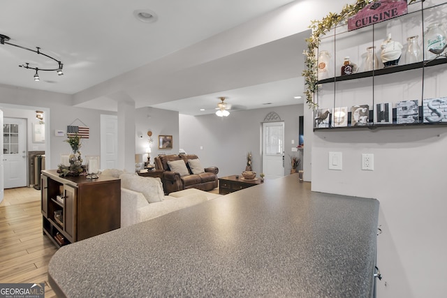 interior space with light wood-style floors, a ceiling fan, and recessed lighting